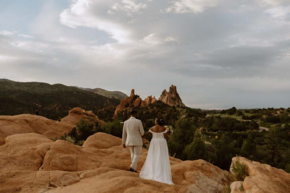 Couple looks out at the landscape of Garden of the Gods in Colorado.